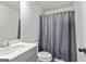 Bathroom featuring a gray vanity with quartz countertop and a shower with gray shower curtain at 209 Osier Dr, Mcdonough, GA 30252