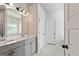 Bathroom with double sinks, a large mirror, and a door to a private lavatory at 209 Osier Dr, Mcdonough, GA 30252