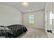 Neutral bedroom with a neutral carpet, light walls, a window and a dark colored bed at 209 Osier Dr, Mcdonough, GA 30252