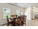 Bright dining area with a wooden table set, large windows, and access to the backyard at 209 Osier Dr, Mcdonough, GA 30252