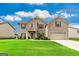 Beautiful two-story brick home with a well-manicured lawn on a sunny day at 209 Osier Dr, Mcdonough, GA 30252