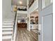 Bright foyer with hardwood floors, staircase, and open floor plan at 209 Osier Dr, Mcdonough, GA 30252
