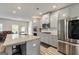 Modern kitchen features stainless steel appliances, white cabinets, and granite countertops at 209 Osier Dr, Mcdonough, GA 30252