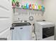 Laundry room area with a washer and dryer and storage above at 209 Osier Dr, Mcdonough, GA 30252