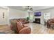 Open-concept living room featuring a fireplace, TV, comfortable sofa, and adjacent dining area at 209 Osier Dr, Mcdonough, GA 30252
