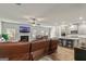 Open-concept living space with a kitchen, dining area, fireplace, and leather sofa at 209 Osier Dr, Mcdonough, GA 30252