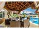 Inviting outdoor living space with covered patio, dining set, and refreshing pool at 209 Osier Dr, Mcdonough, GA 30252