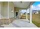Covered back porch with view of yard, with view of houses in neighborhood at 714 Bristol Dr # 279A, Loganville, GA 30052