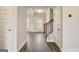 Bright foyer with hardwood floors, staircase, and view into a spacious living area at 714 Bristol Dr # 279A, Loganville, GA 30052
