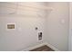 This laundry room has connections for the washer and dryer and overhead wire shelving at 714 Bristol Dr # 279A, Loganville, GA 30052