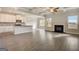Open-concept kitchen and living room with coffered ceilings and a cozy fireplace at 714 Bristol Dr # 279A, Loganville, GA 30052