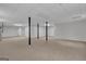 Unfinished basement featuring neutral carpet, gray walls, and support beams at 81 Bowers Rd, Moreland, GA 30259