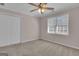 Bedroom featuring beige walls, neutral carpet, a ceiling fan, a bright window and closet at 81 Bowers Rd, Moreland, GA 30259