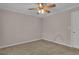Bedroom featuring beige walls, neutral carpet, a ceiling fan, and a bright window and door at 81 Bowers Rd, Moreland, GA 30259