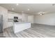 Bright kitchen and living area boasts stainless appliances, granite countertops and modern wood floors at 100 Avondale Blvd, Conyers, GA 30013
