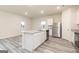 Open-concept kitchen with granite countertops, stainless steel appliances, and luxury vinyl plank flooring at 100 Avondale Blvd, Conyers, GA 30013