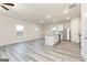 An open-concept living space features luxury vinyl plank flooring and views into the kitchen at 100 Avondale Blvd, Conyers, GA 30013
