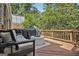 Outdoor deck with comfortable seating, a grill, and lush backyard views, ideal for entertaining at 1718 Ridgewood Ne Dr, Atlanta, GA 30307