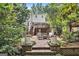 Charming backyard with a deck, brick patio, and lush garden, creating a tranquil outdoor space at 1718 Ridgewood Ne Dr, Atlanta, GA 30307