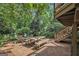 Inviting brick patio with dining set and stairs, surrounded by lush greenery for a serene outdoor experience at 1718 Ridgewood Ne Dr, Atlanta, GA 30307