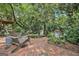Charming brick patio featuring an Adirondack chair, vibrant flowers, and peaceful garden setting at 1718 Ridgewood Ne Dr, Atlanta, GA 30307