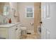 Bright bathroom featuring a marble countertop vanity, stylish fixtures, and tiled walls, exuding modern elegance at 1718 Ridgewood Ne Dr, Atlanta, GA 30307
