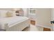 Charming bedroom with white bed frame, plush bedding, and bright window creating a relaxing and inviting atmosphere at 1718 Ridgewood Ne Dr, Atlanta, GA 30307