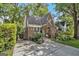 Charming brick Tudor-style home with lush landscaping and a welcoming driveway at 1718 Ridgewood Ne Dr, Atlanta, GA 30307