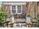 Close-up of a cozy front porch with rocking chairs and potted flowers at 1718 Ridgewood Ne Dr, Atlanta, GA 30307