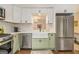 Updated kitchen featuring a stainless steel refrigerator and a farmhouse-style sink at 1718 Ridgewood Ne Dr, Atlanta, GA 30307