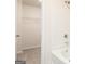Bright bathroom with tub, shower, and a closet featuring shelving for storage at 284 Limestone Circle, Conyers, GA 30013