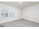 Neutral bedroom features a large window with blinds and neutral carpet at 284 Limestone Circle, Conyers, GA 30013