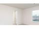 Bright bedroom with soft carpet and window looking out to a new home construction site at 284 Limestone Circle, Conyers, GA 30013