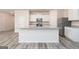 Kitchen with stainless steel appliances, granite countertops, an island, and wood-look flooring at 284 Limestone Circle, Conyers, GA 30013