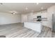 Bright, open kitchen and living area with a large island and stainless steel appliances at 284 Limestone Circle, Conyers, GA 30013