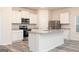 Modern kitchen with stainless steel appliances, a large island, and white cabinets at 284 Limestone Circle, Conyers, GA 30013