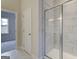 Modern bathroom featuring tiled walls, a glass-enclosed shower, and neutral finishes creating a clean and inviting space at 402 Westmarch Cir # 285A, Loganville, GA 30052