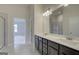 Well-lit bathroom with double sink vanity and a large mirror, complemented by a shower with tiled walls at 402 Westmarch Cir # 285A, Loganville, GA 30052