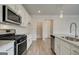 Updated kitchen with stainless steel appliances, granite countertops, white cabinets and large pantry at 402 Westmarch Cir # 285A, Loganville, GA 30052