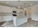 Well-lit kitchen with white cabinets, granite countertops, stainless steel appliances, and island at 402 Westmarch Cir # 285A, Loganville, GA 30052