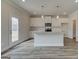 Modern kitchen featuring white cabinets, granite countertops, stainless steel appliances, and island at 402 Westmarch Cir # 285A, Loganville, GA 30052