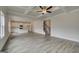 Open-concept living area with hardwood floors, coffered ceiling, staircase and kitchen with island at 402 Westmarch Cir # 285A, Loganville, GA 30052