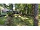 The backyard boasts wooded area with brick terrace and stairs leading up to the home's deck at 4710 Cedar Brook Se Dr, Conyers, GA 30094
