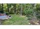 Spacious backyard with mature trees, lush lawn, and a garden area at 4710 Cedar Brook Se Dr, Conyers, GA 30094