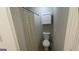 Well-lit bathroom with neutral gray walls, white trim, toilet, and shower with patterned curtain at 4710 Cedar Brook Se Dr, Conyers, GA 30094
