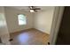 Sunlit bedroom with neutral walls, wood-look floors, ceiling fan and a window at 4710 Cedar Brook Se Dr, Conyers, GA 30094
