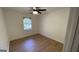 Bright bedroom with a ceiling fan, window with blinds, and wood-look flooring at 4710 Cedar Brook Se Dr, Conyers, GA 30094