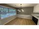 Dining area featuring modern light fixture, decorative wall pattern, and wood floors at 4710 Cedar Brook Se Dr, Conyers, GA 30094
