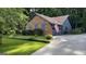 Home with brick and siding exterior, showcasing a well-maintained lawn and driveway at 4710 Cedar Brook Se Dr, Conyers, GA 30094
