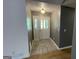 Foyer showcasing a light fixture and white front door with detailed tile flooring, radiating a bright welcome at 4710 Cedar Brook Se Dr, Conyers, GA 30094